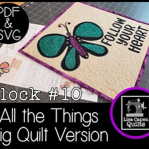 May include: Block #10 of the "All the Things" quilt pattern featuring a butterfly with teal and purple wings and the text "Follow Your Heart". The block is surrounded by a purple border and is on a beige background. The image also includes a logo for Lisa Capen Quilts.