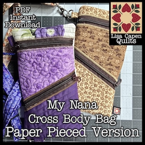 May include: Two cross-body bags with diagonal zippers. One is purple with quilted details, the other is tan with a floral pattern. The text "My Nana Cross Body Bag Paper Pieced Version" is visible. The bags are designed by Lisa Capen Quilts.