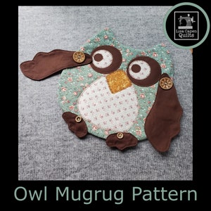 May include: A handmade owl mugrug pattern. The owl is made of fabric with a floral pattern in shades of green and white. It has brown wings, eyes, and accents, with wooden button details. The text "Owl Mugrug Pattern" is at the bottom.