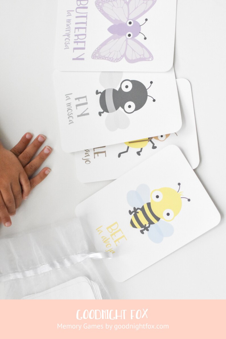 May include: A set of colourful flashcards featuring illustrations of a butterfly, fly, and bee. Each card has the English and Spanish names for the insect. The cards are part of a memory game set by Goodnight Fox.