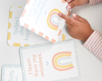 May include: A set of affirmation flashcards featuring rainbow illustrations and positive messages. The cards include phrases like "I learn from my mistakes" and "Today I choose happiness".