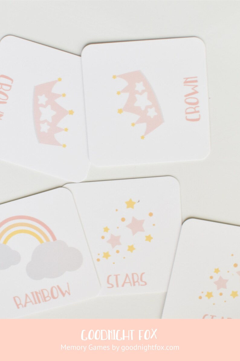 May include: A set of pink and yellow memory game cards featuring images of a crown, stars, and a rainbow. The cards are labeled with the words "crown", "stars", and "rainbow". The cards are part of a memory game by Goodnight Fox.