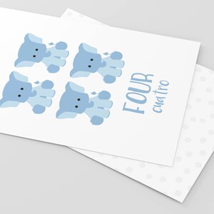 May include: A white card with four blue elephant illustrations and the text "FOUR cuatro" in blue.