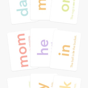 May include: Flash cards with words like "dad," "mom," and "my" in various colors. The cards also feature simple sentences such as "The rug is on the floor." The bottom of the image reads "GOODNIGHT FOX Flash Cards by goodnightfox.com."