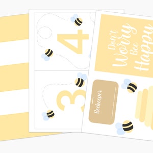 Flat lay of bee keeper pretend play materials, including flower matching cards, printable honeycombs, and a pretend play bee hive.