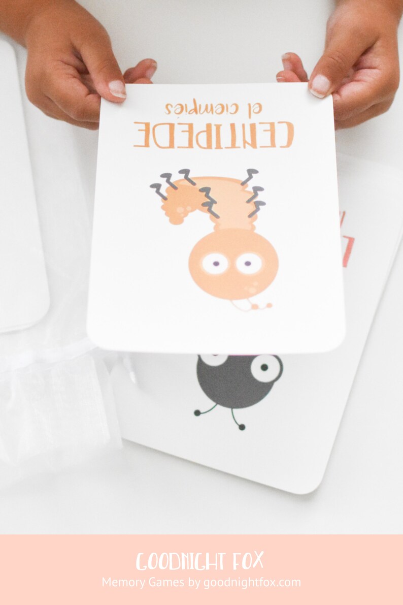May include: A white card with a cartoon illustration of a brown centipede with black legs and large eyes. The text "CENTIPEDE" is written in black above the illustration and the text "of course" is written in black below the illustration.