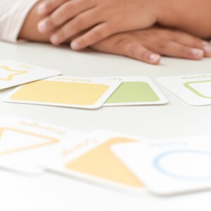 May include: A set of colorful memory game cards featuring shapes and colors. The cards are laid out on a white table. The text "AGES 2+" and "GOODNIGHT FOX Memory Games by goodnightfox.com" are visible in the image.