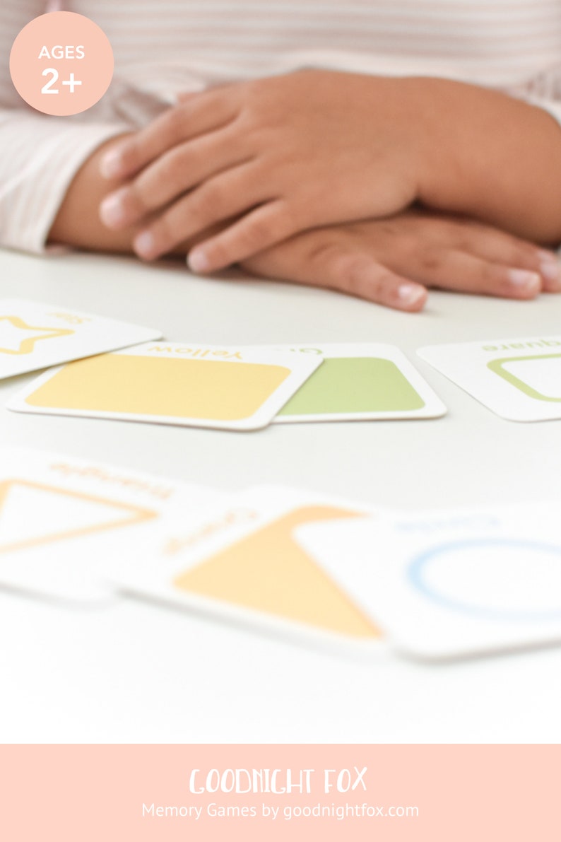 May include: A set of colorful memory game cards featuring shapes and colors. The cards are laid out on a white table. The text "AGES 2+" and "GOODNIGHT FOX Memory Games by goodnightfox.com" are visible in the image.