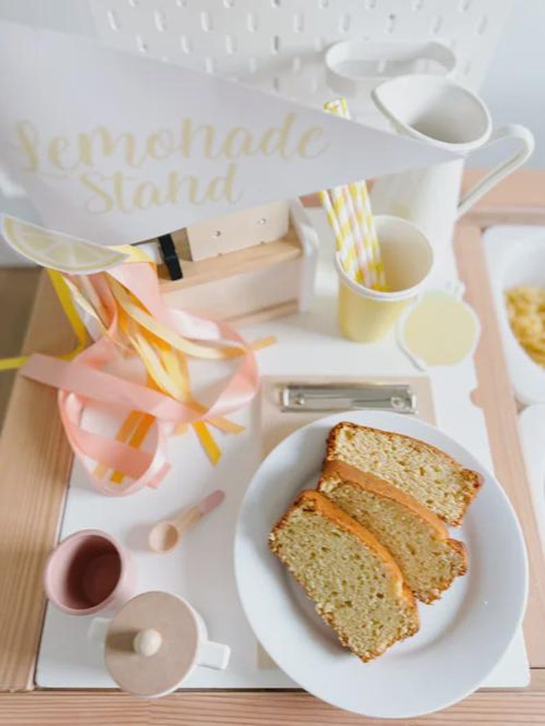 Summer toddler activity using lemonade stand printable kit to practice early math concepts like pricing and money exchange through imaginative and engaging dramatic play.