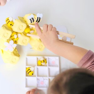 Bee keeper pretend play setup in a classroom environment, engaging preschoolers in a collaborative role-playing activity.