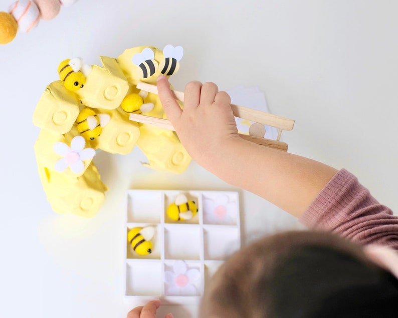 Bee keeper pretend play setup in a classroom environment, engaging preschoolers in a collaborative role-playing activity.
