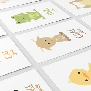 May include: Set of 10 printable flashcards featuring different animals with their names in English. The animals include a cat, pig, frog, goat, owl, duck, horse, cow, and a fish. The flashcards are designed in a simple, colorful style with a white background.