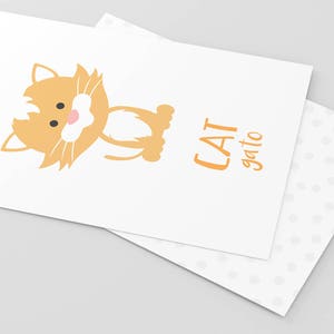 May include: A white card with a cartoon orange cat and the text "CAT gato" in orange.
