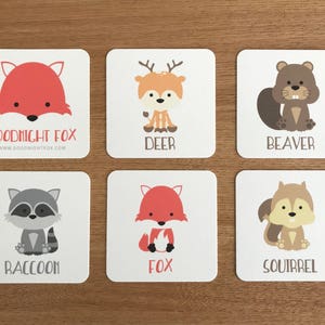 May include: Six colorful cards with illustrations of animals, including a fox, deer, beaver, raccoon, squirrel, and another fox. Each card has the name of the animal printed in black text below the illustration. The top card has the text "Goodnight Fox" and a website address.