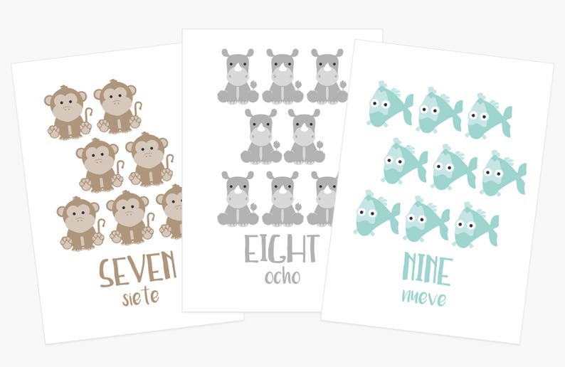 May include: Three white cards with illustrations of animals and numbers. The first card shows seven brown monkeys with tails, the second card shows eight gray rhinos, and the third card shows nine light blue fish. Each card has the number written in English and Spanish.