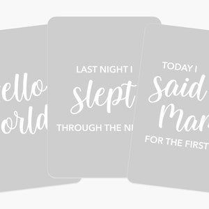 May include: Three gray cards with white text. The first card says "Hello World". The second card says "Last night I slept through the night". The third card says "Today I said Mama for the first time".