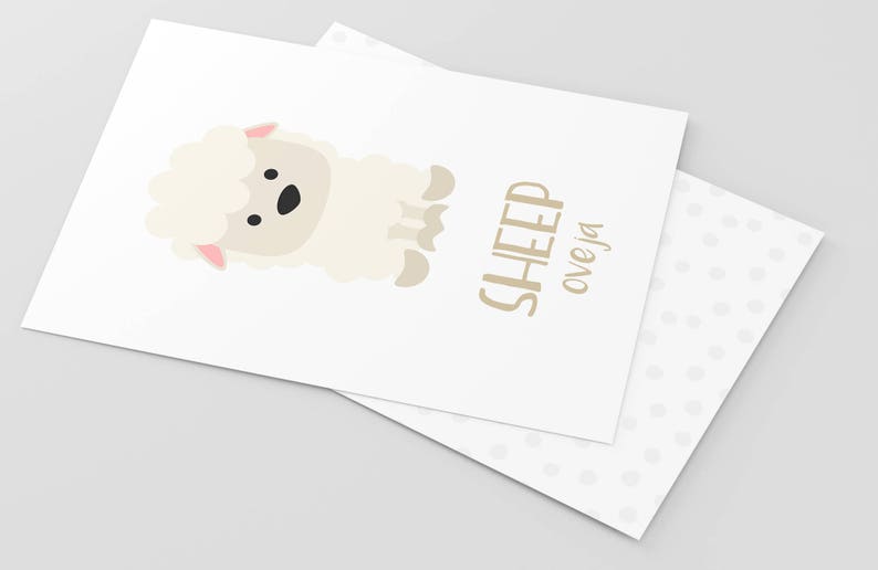 May include: A white sheep with a pink nose and black eyes is illustrated on a white card with the text "SHEEP oveja" in brown lettering.