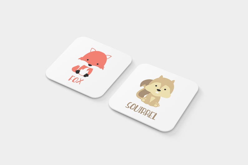 May include: Two white square cards with illustrations of a fox and a squirrel. The fox is orange and the squirrel is brown. The cards have the words "Fox" and "Squirrel" printed on them.
