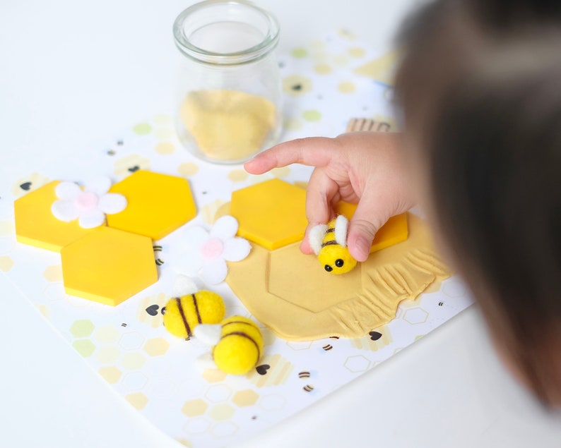 Bee keeper dramatic play printables displayed with Montessori tools like scoops, tongs, and color-sorting bowls.