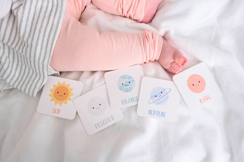 May include: A set of six colorful flash cards featuring illustrations of the sun and planets. The cards are white with black text and feature the names "Sun", "Mercury", "Uranus", "Neptune", and "Mars".