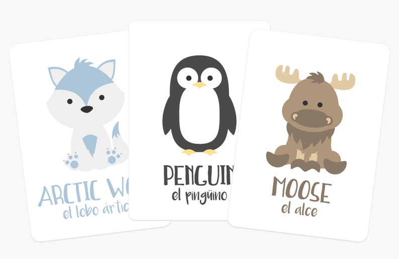 May include: Three flashcards with illustrations of an arctic wolf, a penguin, and a moose. Each card has the animal's name in English and Spanish.