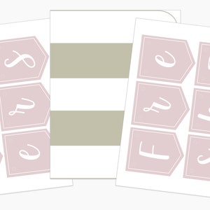 May include: Sheets of paper with a banner design in a soft pink colour. The banners have white outlines and white cursive lettering spelling out "SWEET". A striped paper with white and tan stripes is also visible.