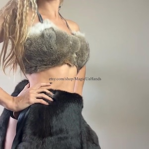 May include: A two-piece outfit featuring a fur top and skirt. The top is a light gray fur, and the skirt is black fur. The outfit is designed with a halter top and a wrap-style skirt. The Etsy shop name "MagicUaHands" is visible.