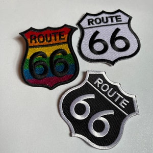 May include: Three Route 66 patches. One is white with black text, one is black with white text, and one is rainbow with black text.
