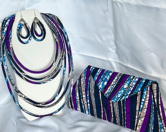 May include: A set of matching accessories featuring a multi-colored fabric with blue, purple, and white stripes. The set includes a necklace, earrings, and a clutch.