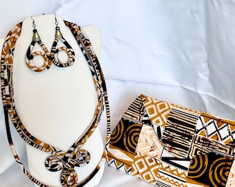 May include: A set of brown and black patterned fabric jewelry, including a necklace and earrings, and a matching clutch bag. The fabric has a geometric design with white accents.