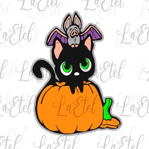 May include: A Halloween-themed illustration of a black cat with green eyes inside an orange pumpkin. A grey bat with purple wings sits on the cat's head. The image has a white background and the text "La Etel" is watermarked across the image.