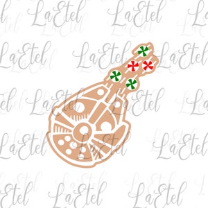 May include: A brown and white Millennium Falcon spaceship with red and green candy canes attached to the top. The candy canes are arranged in a festive pattern.