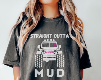 May include: A dark gray t-shirt with a white graphic of a jeep with the text "STRAIGHT OUTTA MUD".