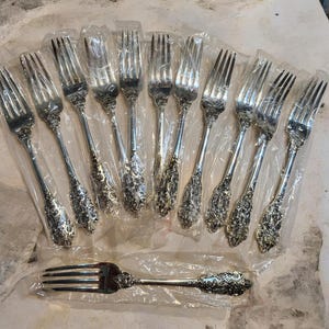 May include: A rustic wooden sign with the text "Welcome to our home" in white lettering. The sign features a distressed finish and a simple, inviting design, perfect for entryway decor.