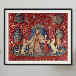 May include: A framed wall art print featuring the Lady and the Unicorn tapestry. The scene depicts a central figure standing under a blue tent, flanked by a lion on the left and a unicorn on the right, set against a vibrant red floral background.