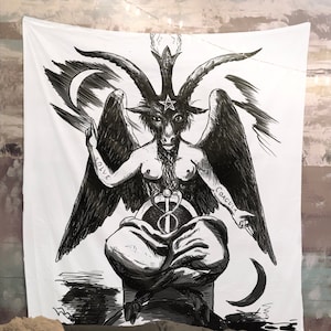 May include: Black and white illustration of a winged, horned figure with a pentagram on its forehead. The figure is sitting on a throne with a snake wrapped around a sword. The words "Solve" and "Coagula" are written on the figure's arms.