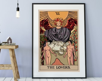 May include: A framed wall art print of The Lovers tarot card featuring a central winged figure above two standing figures, with a sun, clouds, and foliage in a warm color palette. The text VI and THE LOVERS are printed on the card design.