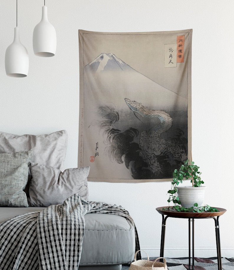 May include: A tapestry featuring a Japanese-style illustration of Mount Fuji with a dragon emerging from the clouds. The tapestry has a beige background with black and gray details. The text "月 昇 龍 天" is written in black on the right side of the tapestry.