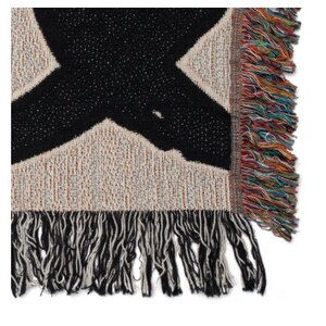 May include: A woven throw blanket with a large black X design on a beige background. The blanket has a fringed edge with a mix of colorful threads. The texture of the blanket is visible, showing the weave of the fabric.