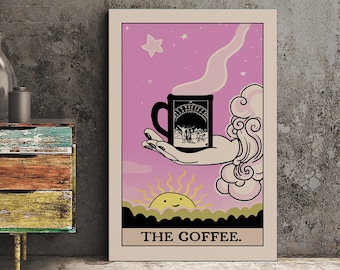 May include: A rectangular wall art print featuring a tarot card design with a pink background, a hand holding a black mug with steam, a smiling sun, and clouds. The text THE COFFEE. is printed in black at the bottom of the cream-colored border.