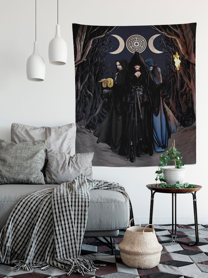 May include: A tapestry depicting three figures in dark cloaks, set against a backdrop of a moon and a labyrinth symbol. The figures are in a forest setting, with a torch held by one. The color palette is dark, with shades of black, gray, and blue.
