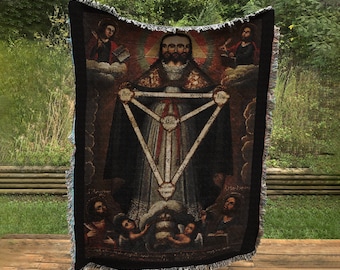 May include: Woven tapestry throw blanket featuring a religious icon with a central figure and surrounding figures. The artwork includes a geometric design and text, with a black fringe border. The color palette includes shades of brown, red, and gold.