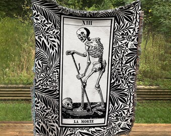 May include: Black and white woven tapestry featuring a tarot card with a skeletal figure holding a scythe. The card is labeled "XIII LA MORTE".