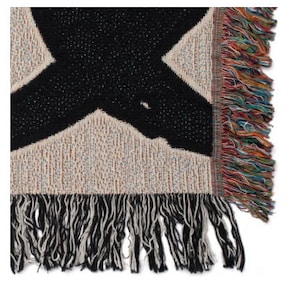 May include: Black and white woven throw blanket with a geometric pattern and fringe on the edges.