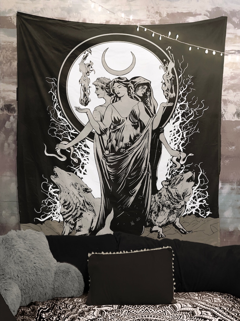 May include: Black and white tapestry featuring a triple goddess figure with a crescent moon above her head. She is surrounded by wolves and a snake. The tapestry has a dark background and a white circle around the goddess.