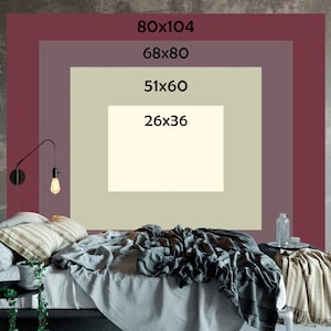 May include: A bedroom with a bed, a nightstand, and a wall with different sized frames. The frames are labeled with the dimensions of the image inside. The largest frame is 80x104 inches, the next is 68x80 inches, the next is 51x60 inches, and the smallest is 26x36 inches.