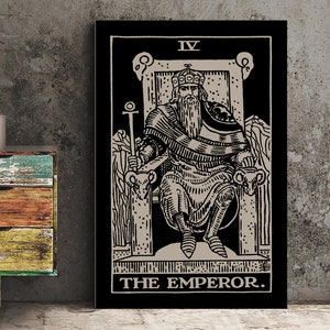 May include: Black and white tarot card illustration of The Emperor, card number IV. The Emperor is sitting on a throne with a crown on his head and a scepter in his hand. He is surrounded by rams.