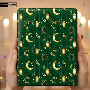 May include: A wrapped gift with a green background and a repeating pattern of gold crescent moons, lanterns, stars, and geometric shapes. The text "The Family SMITH" is repeated throughout the design. The gift is held by two hands.