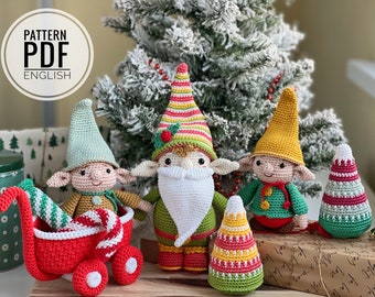 May include: Crochet pattern PDF for making five Christmas gnomes. The gnomes are green, red, and yellow with white beards and candy cane accents. The pattern is in English.