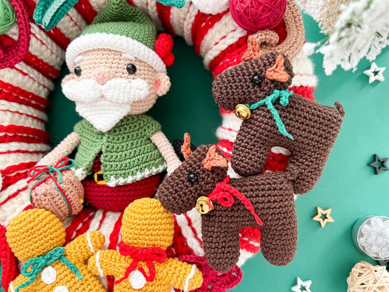 May include: A crocheted Christmas wreath with a Santa Claus, two reindeer, and two gingerbread people. The wreath is decorated with red and white candy canes.